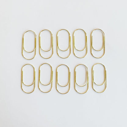 Big metal paper clip in gold finish