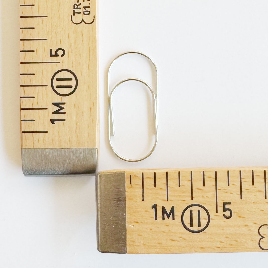 Big metal paper clip holding fabric, detail