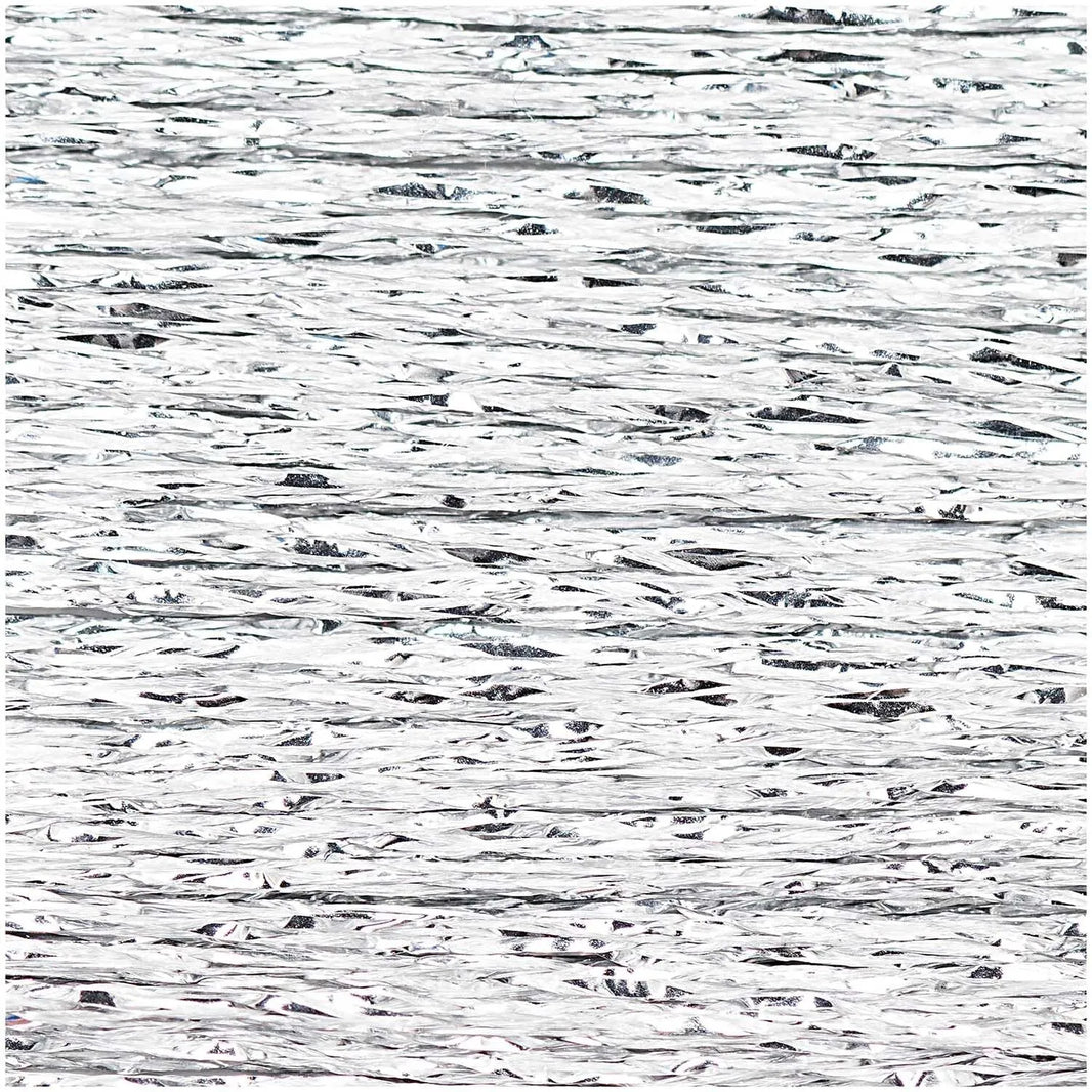 Close-up of shimmering silver metallic embroidery thread texture