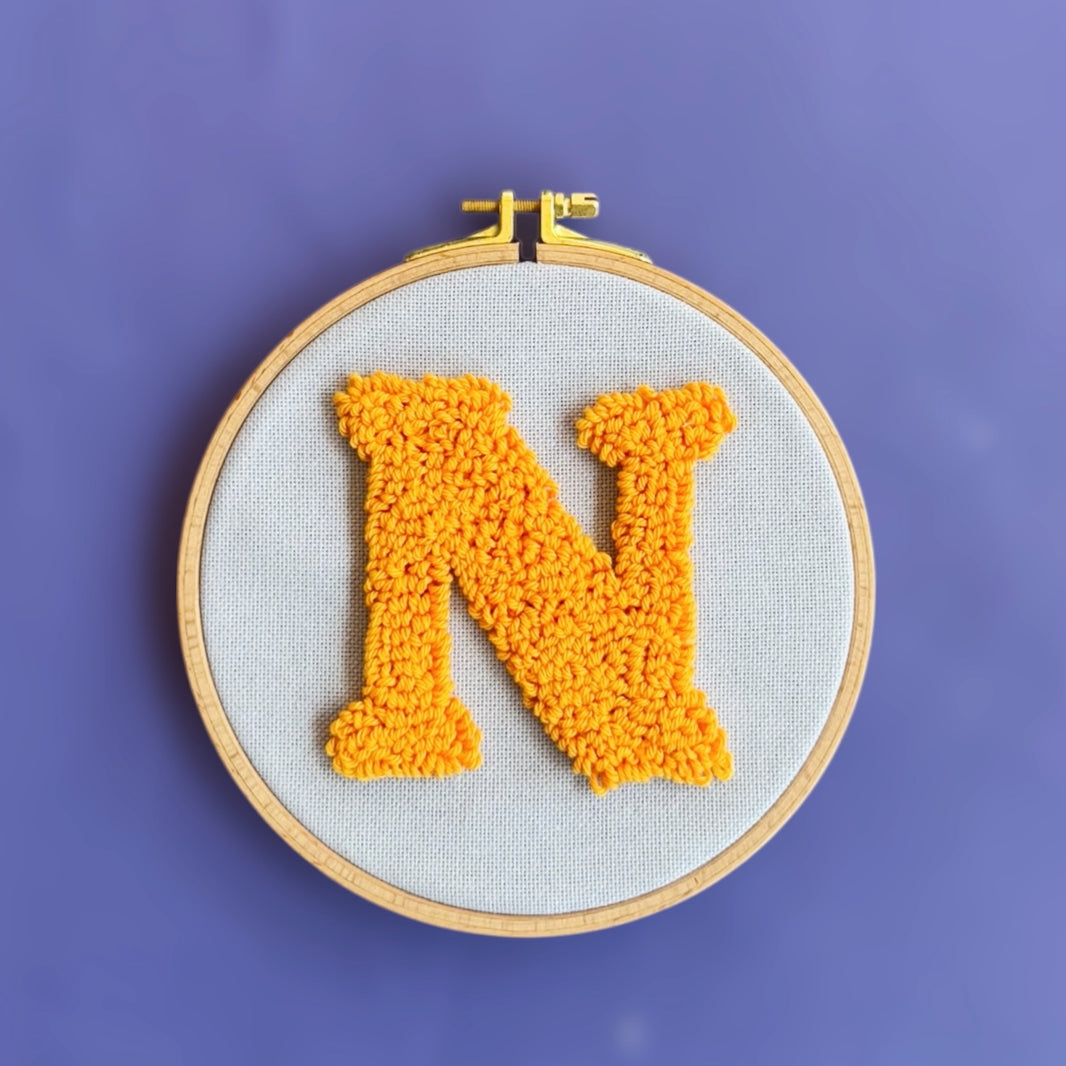Letter punch needle wallpiece detail